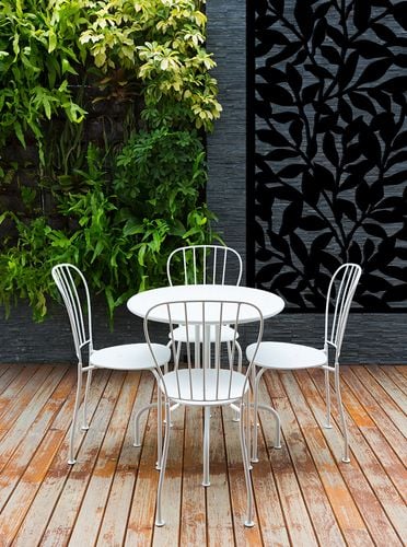 Backyard deck with small, white table and chairs