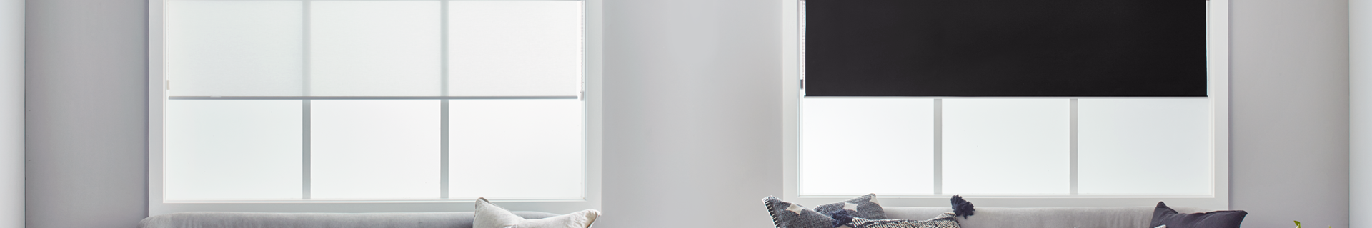 Living room with black roller blinds.