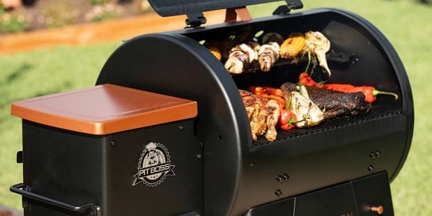 Smoker with grilled meats and vegetables.