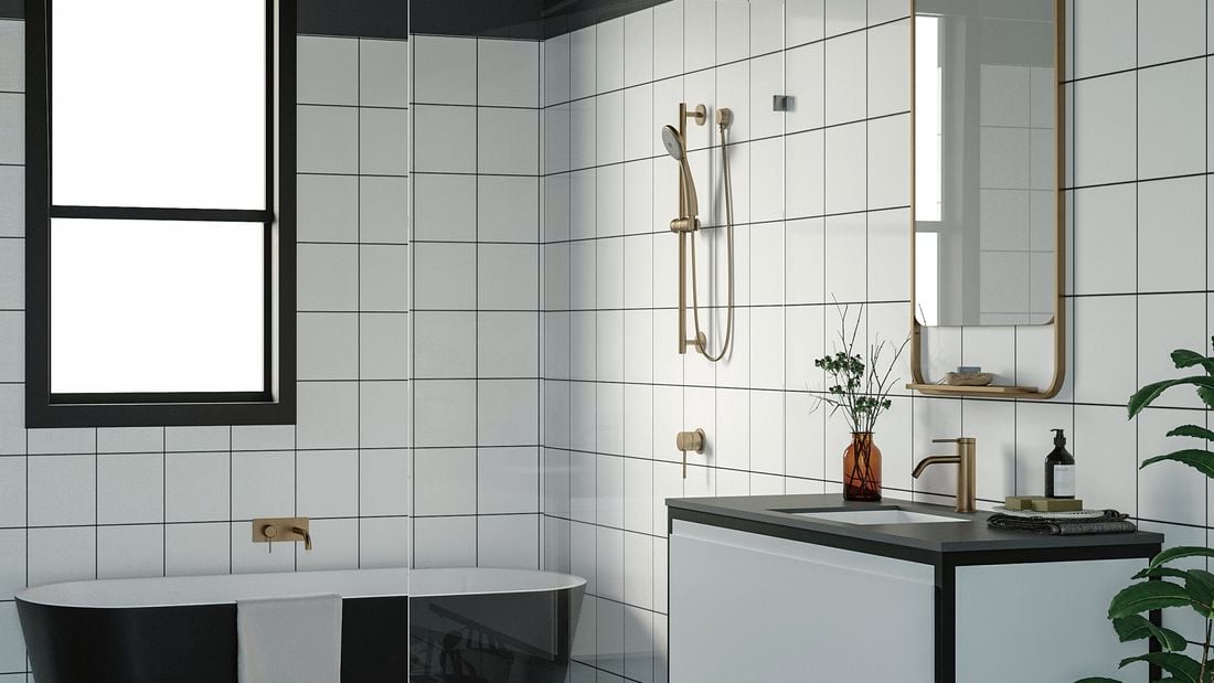 Bathroom with black bathtub and wash basin along with golden fittings, mirror and black and white floor.