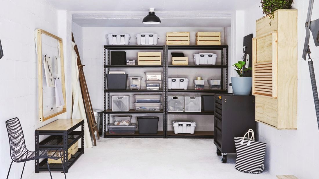 An organized and spacious garage with storage cabinets, wall-mounted racks, and a clean floor finish.