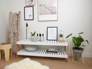 DIY slatted shelving unit against wall with decorations.