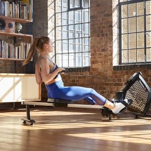 Woman on a rowing machine - Medium - Reebok