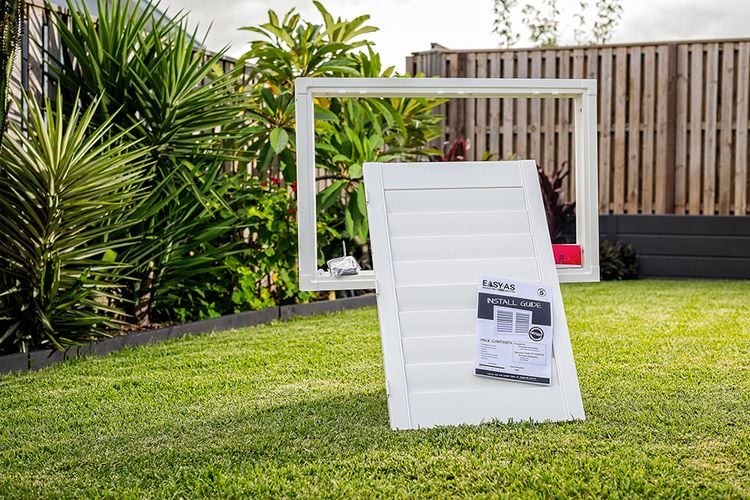 An EasyAS frame and blind screen posed in a backyard