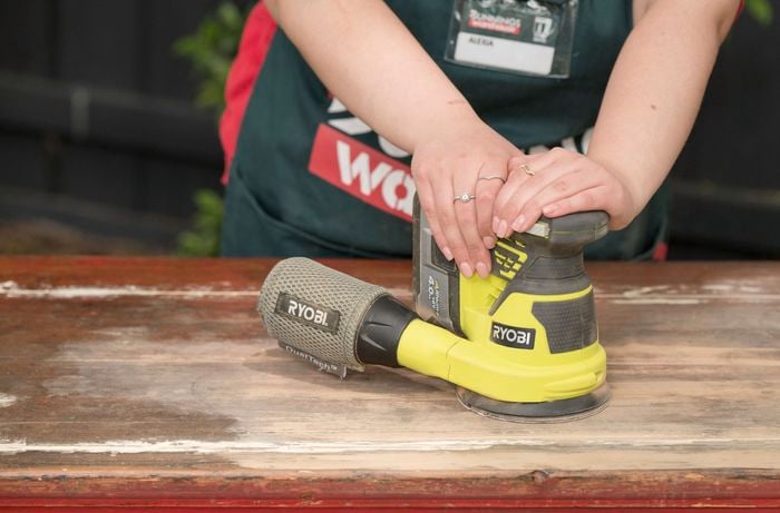 Bunnings TM sanding the  table
