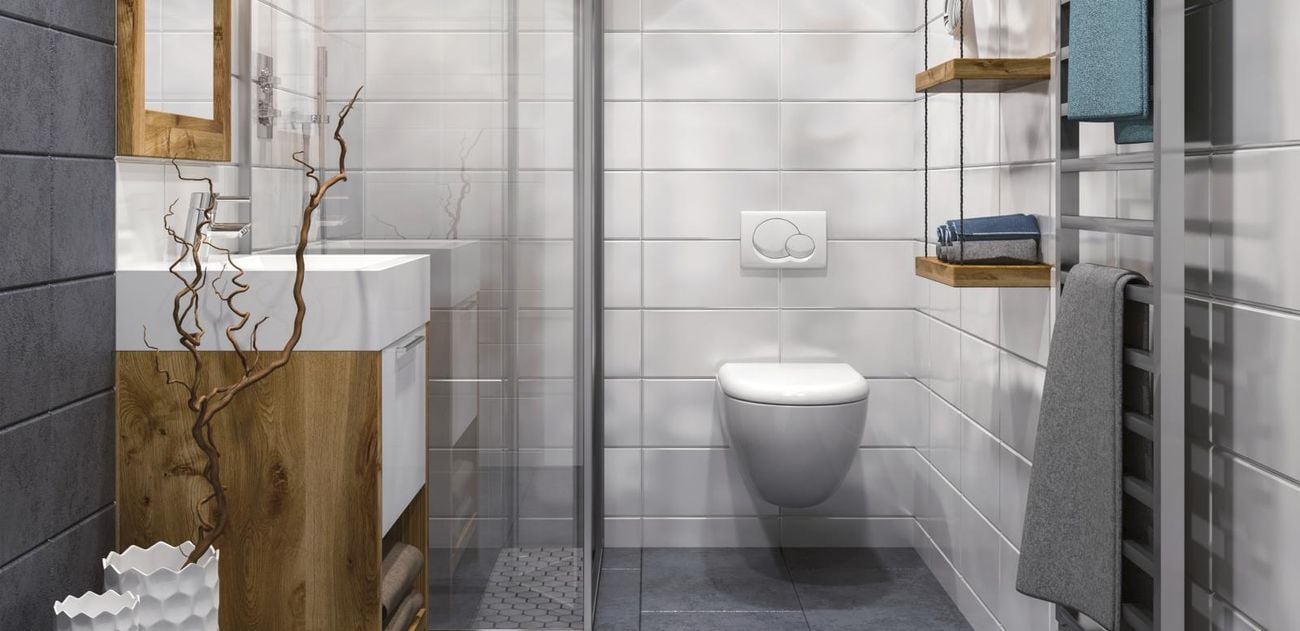 Bathroom with white sink and toilet and a timber sculpture