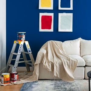 A living room with different paint colours sampled on a wall.