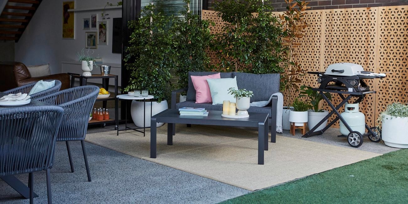 Outdoor setting in courtyard next to BBQ and plants