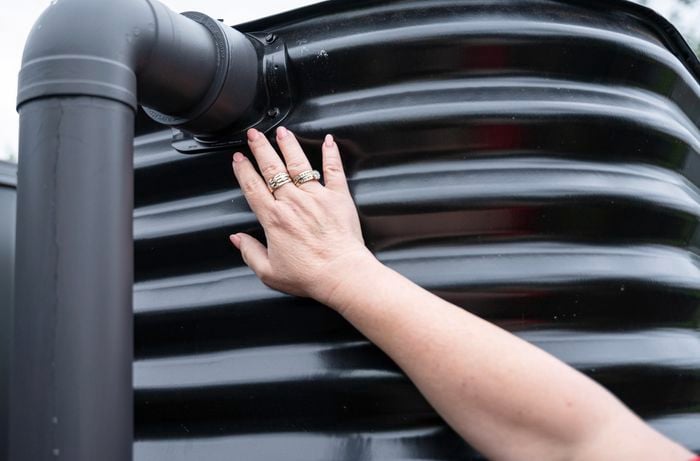 Bunnings team member reviewing the pipe connected to a water tank