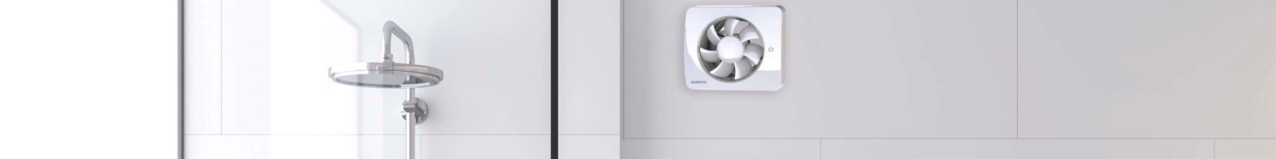 White tiled modern bathroom with a bathtub, shower, floating sink vanity and exhaust fan.