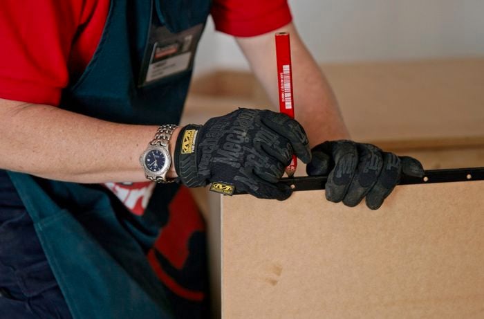 Marking the spots where the screws will go using a red marker pen.