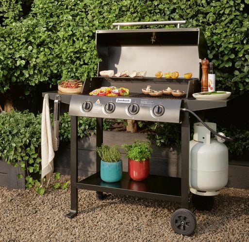 Jumbuck bbq with food cooking in front of green hedges