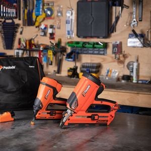 Two Paslode power tools infront of a Paslode tool bag