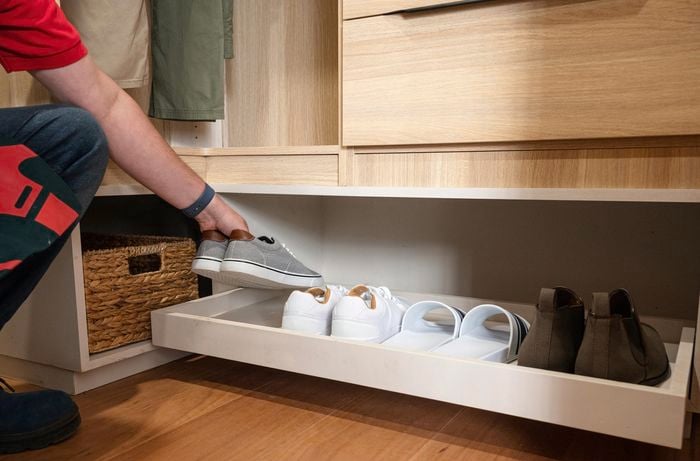 Pull out shelf used for storage of shoes 