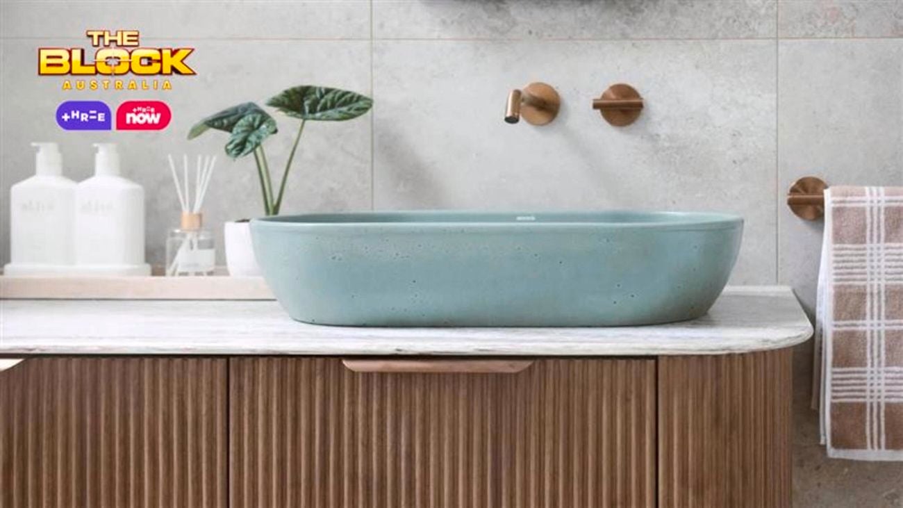 Blue oval basin on a brown timber fluted profile.