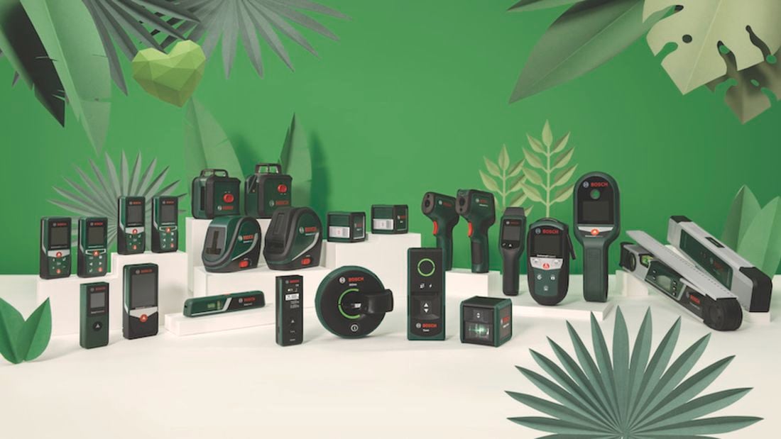 Full range of Bosch sustainable measuring tools styled on a green background.