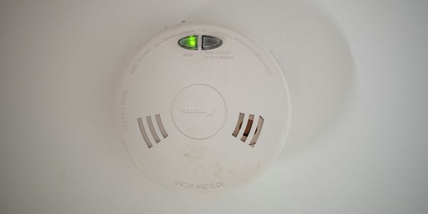 close up of a smoke alarm on a wall