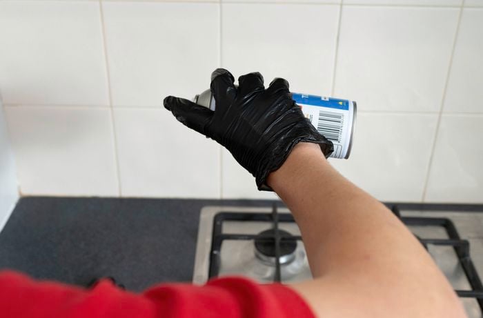 Apply a second coat of grout sealer on a kitchen tiled wall 