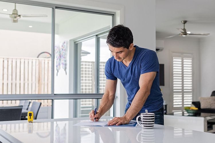 A man in the kitchen with a coffee