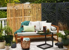Fenced backyard with lawn, plants and outdoor barbeque