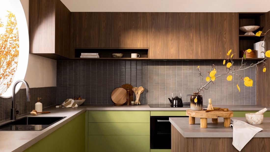 Dark wood and green kitchen with concrete benchtops