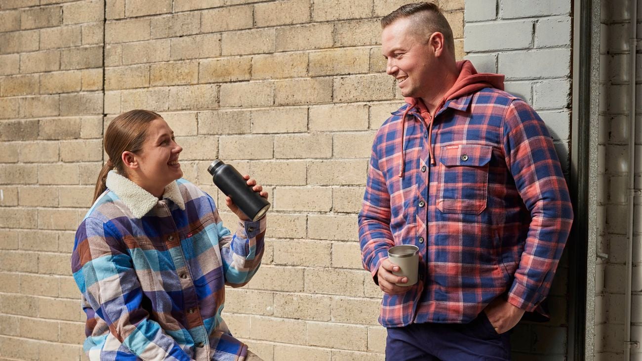 A man and woman in Hard Yakka work apparel, including Mens Legends Safety Boot in Wheat and Womens 3056 Side Zip Boots in Wheat]