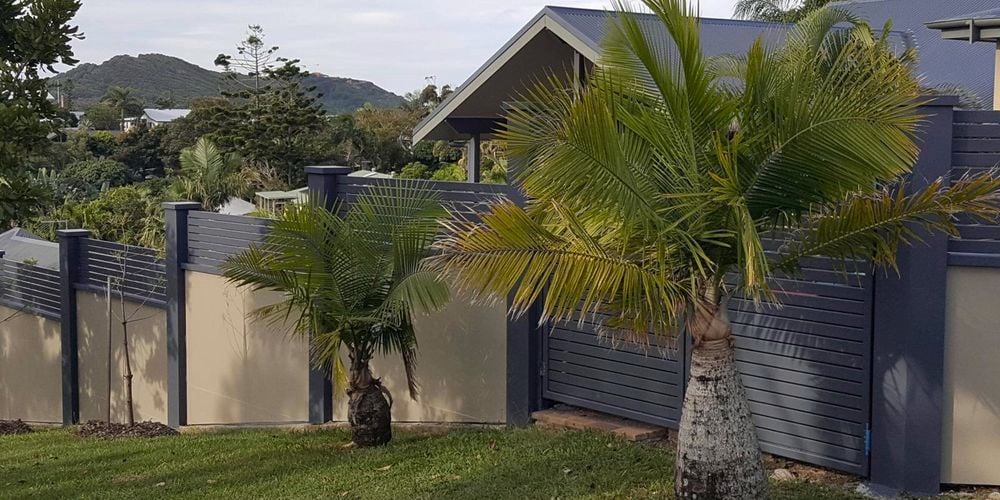 Slenderline Acoustic Fencing slanted fencing with trees in shot 