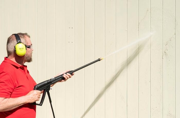 Clean house exteriors using a pressure washer 