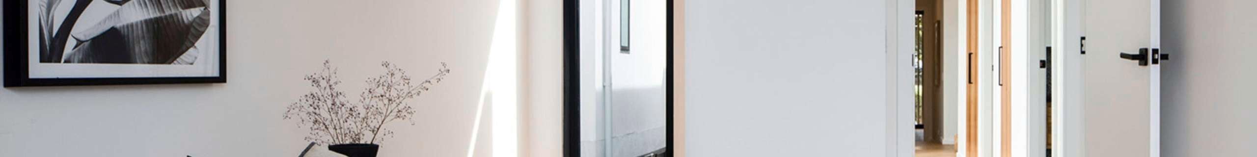 Bedroom with views of numerous doors with black door hardware profiles.