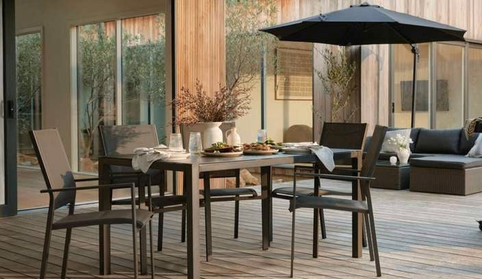 Modern outdoor entertaining space on the deck in the backyard of the home