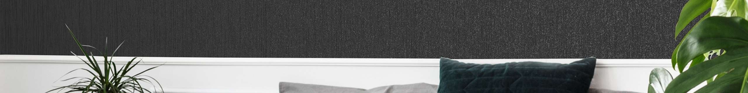 A bedroom wall with a black disco glitter wallpaper.