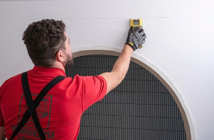 Team member finding the studs with a stud finder.