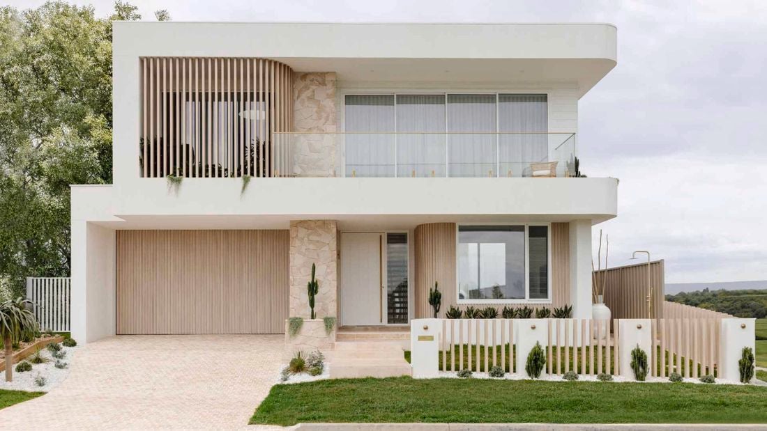 A modern house with cladding and a white exterior.