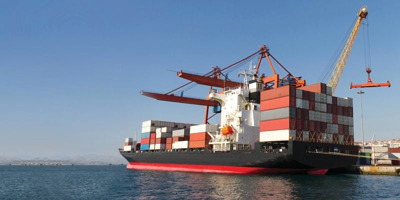 A ship loaded with shipping containers at dock