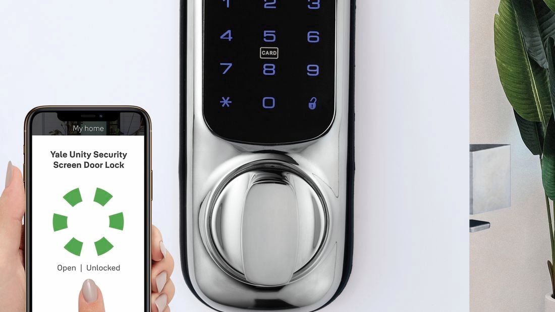 Hand holds phone with a loading screen on it. A door with a smart lock is also pictured, which the phone is wirelessly connecting to