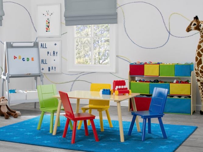 Kids play area with colourful chairs, table, white board and toy storage.