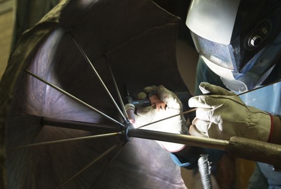 Person welding while wearing mask
