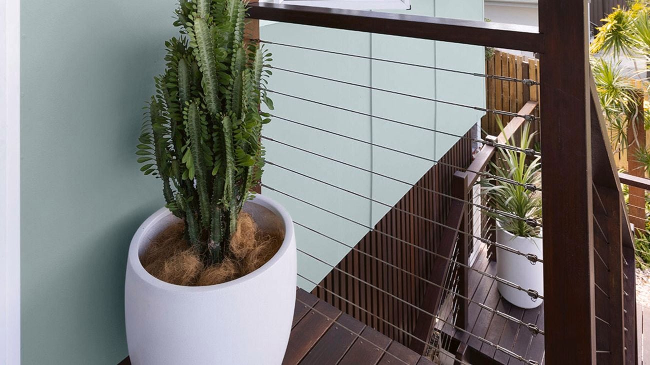 Exterior deck stairs of a two-storey home. Deck and railings stained in Intergrain Merbau.