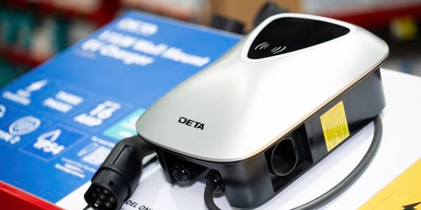 The image shows a DETA 11kW Wall Mount EV Charger, featuring a sleek silver design and a Type 2 connector, highlighted for its fast charging capabilities and IP54 rating. 