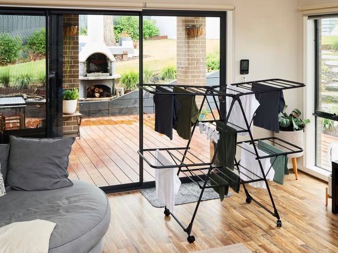 Hills Deluxe 2 Tier Airer with clothes on it in a living room.
