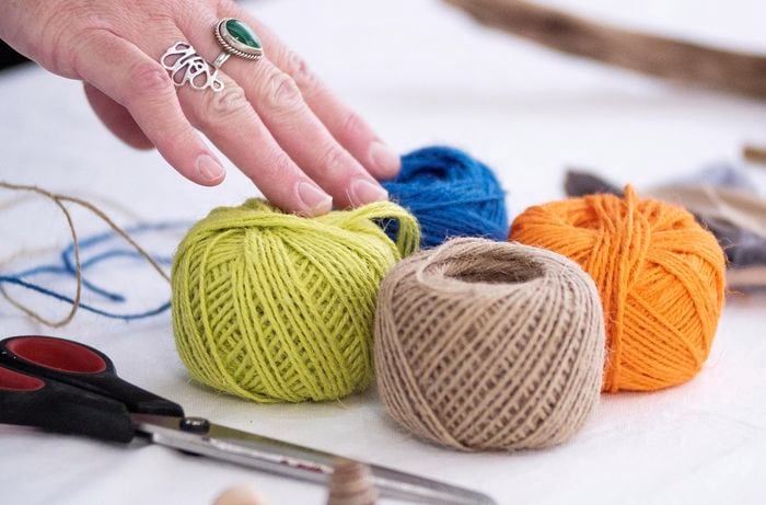 Green, blue, orange and brown rolls of string.