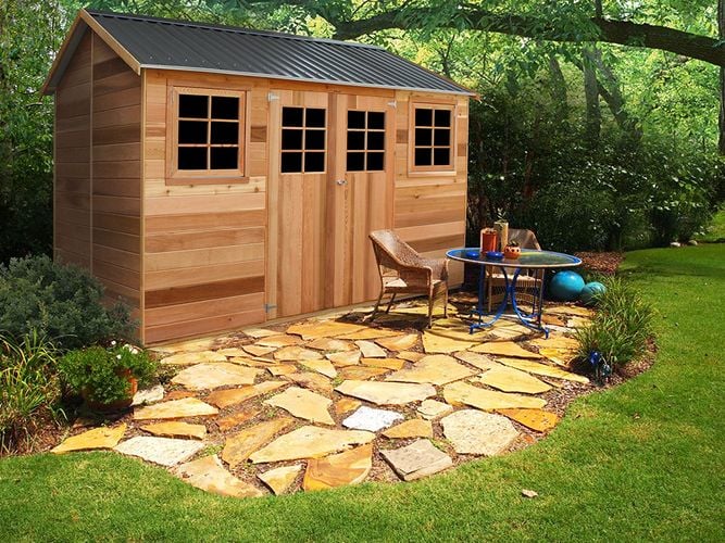 Timber shed with gable roof, double doors and windows in a garden setting
