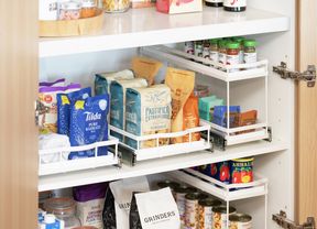 Organised pantry cupboard featuring pull-out storage drawers and shelves