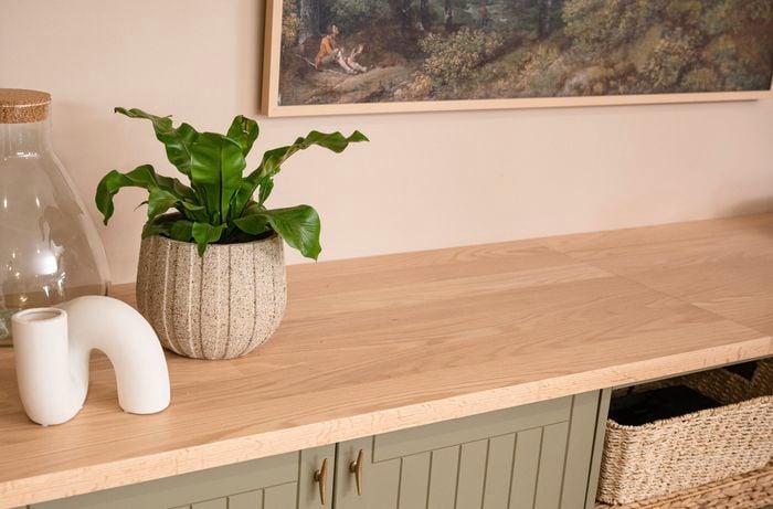 Cabinet with timber top, vases and baskets in the back ground