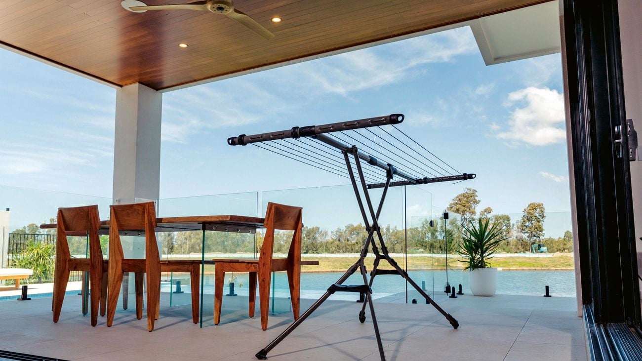 Portable clothes drying rack in an outdoor room