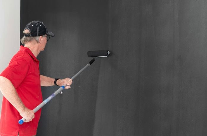 Applying a second coat of paint to the feature wall