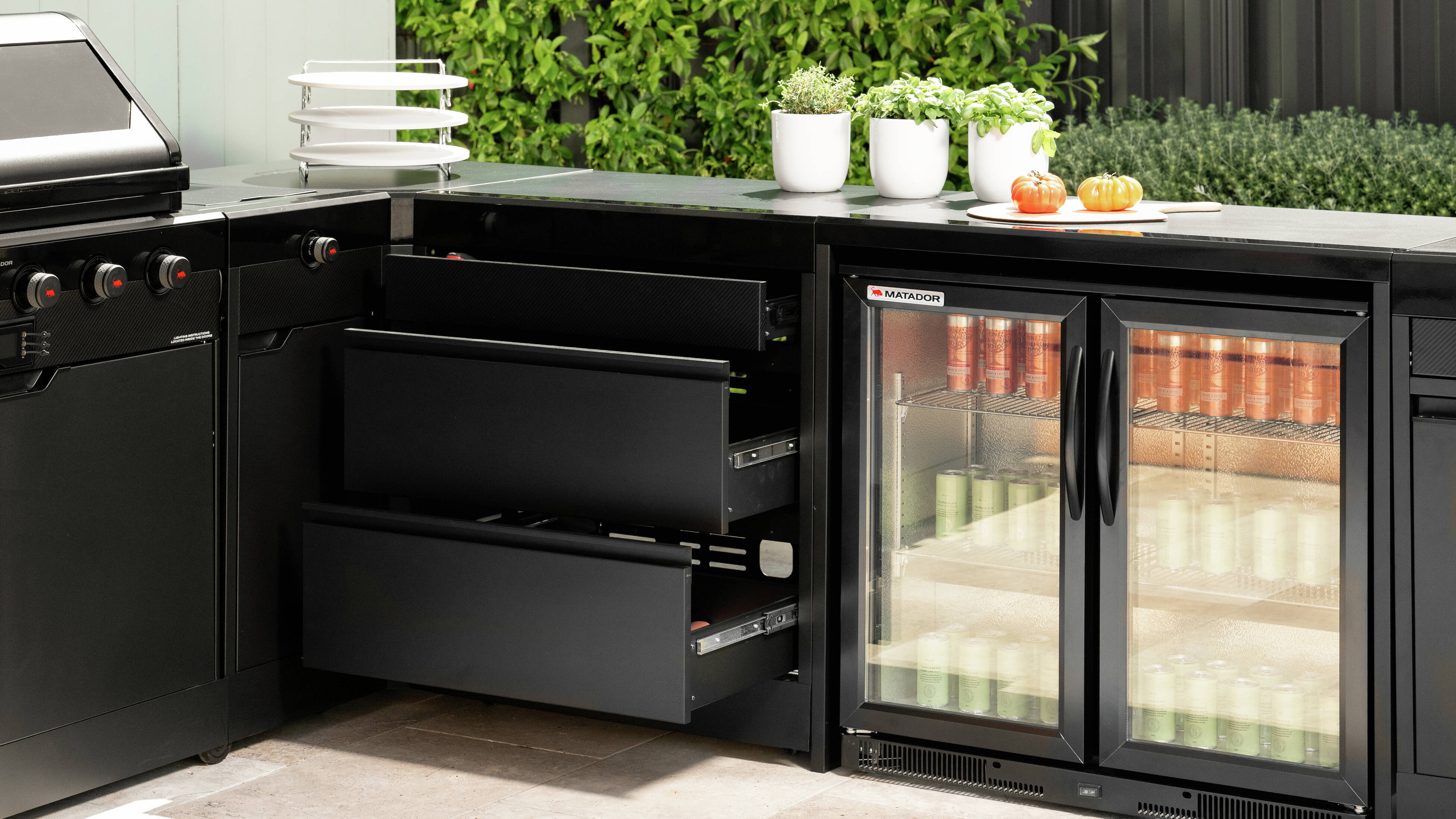 Open drawers and bar fridge in a Matador outdoor kitchen 