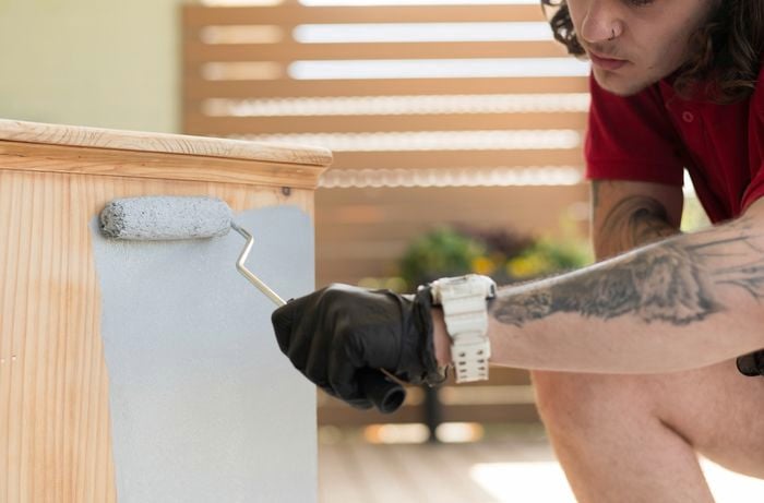 Applying primer with a roller.