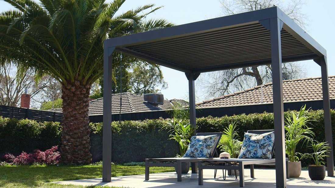 Gazebo over lounge chairs in backyard area.