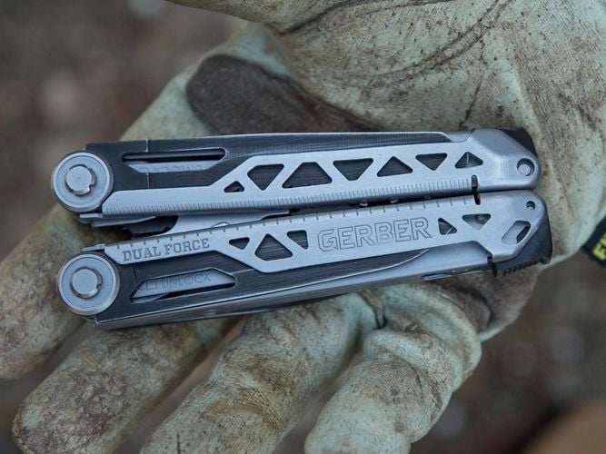A person holding a dual force multi tool.